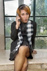 Girl In Formal Attire Wearing Net Stockings And High Heels Calling By  Cellphone In A Dirty Neglected Urban Setting With Graffiti. Caveat: ( she)male Impersonator. Stock Photo, Picture and Royalty Free Image. Image