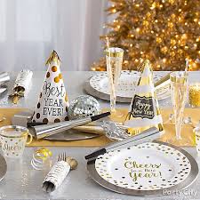 Surround it with your favorite metallic fans, hanging metallic fringe, silvery paper lanterns, and thematic new year's eve cutout decorations. White And Gold New Year S Eve Party Ideas Party City