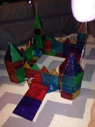 Small squares were arranged across the window sill behind a decorative snowflake light! 110 Magna Tiles Ideas Magna Tiles Tiles Magnetic Tiles