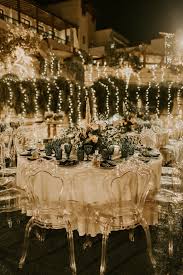 Picture Of The Wedding Reception Was Outdoors With Neutral Blooms And Greenery And Cool Ghost Chairs