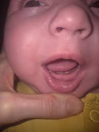 Cute baby with fingers in mouth