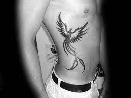 Flying Tribal Phoenix Male Black Ink Tattoo Design On Ribs Tribal Phoenix Tattoo Phoenix Tattoo For Men Phoenix Tattoo