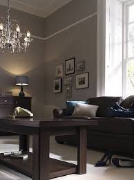 Warm Earth Tones Are Good For A Living Room As They Stimulate Conversation Brown Living Room Decor Grey And Brown Living Room Living Room Colors