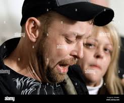 Greg Henley, left, the son of death row inmate Steve Henley, weeps as he  reads a statement after his father, death row inmate Steve Henley, was  executed at Riverbend Maximum Security Institution