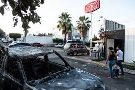 Fighters in black masks could be seen firing bullets from trucks when the violence erupted (picture: After Soldiers Surrender El Chapo S Son A Shocked Mexican City Sighs With Relief The New York Times