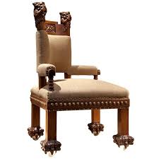 An American Gilded Age Upholstered Corner Chair Made Of Walnut With Glass Ball Feet The Carved Wood Finials Feature Bears Grasping And Bit Corner Chair Chair Latest Furniture Designs