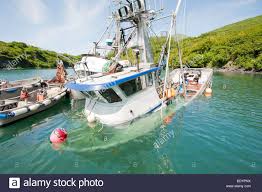 alaska, kodiak. a boat sinks after