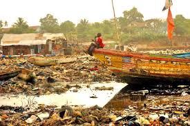 A Boy Sits On A Boat In The Harbor Of Kroo Bay In Freetown Sierra Leone Freetown Sierra Leone Travel Dreams