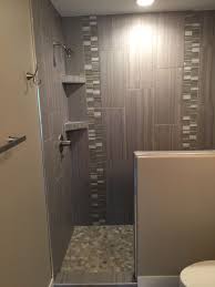 Custom Tiled Shower In 12x24 Porcelain Tile Installed At A 1 3 Staggered Vertically With A Glass And Stone Custom Tile Shower Shower Tile Vertical Shower Tile