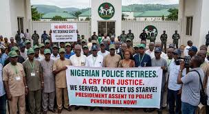 Retired police officers block villa gate, demand exit from contributory  pension scheme Retired police personnel, alongside their families under the Police  Retired Officers Forum of Nigeria (PROF), have staged a protest in