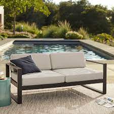 An outdoor lounge sofa is a perfect place for relaxation in a cool autumn day. Portside Aluminum Outdoor Sofa