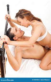 Playfull Adult Couple Having Sex on Bed in Bedroom Interior Stock Image 