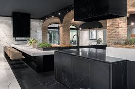 Daltile has a really nice 24x24 black porcelain body tile called flashpoint, but it's not quite big enough to span the entire distance of the counter so along the wall there would be smaller tiles to fill the space. Luxury Kitchens Countertops Porcelain Tiles