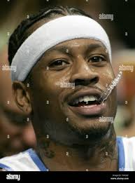 Denver Nuggets guard Allen Iverson holds his mouthpiece during a timeout in  the first quarter against the Minnesota Timberwolves at the Pepsi Center in  Denver