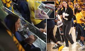 Caitlin Clark is bizarrely asked to sign a fan's ultrasound picture during  a Pacers playoff game as basketball's new star is given a standing ovation  from 17,000-strong Indiana crowd | Daily Mail