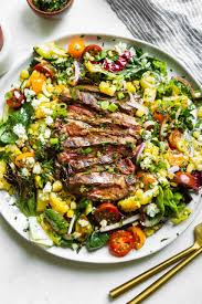 To assemble the salad, place the mixed greens on a large platter. 9jq84p8c7fm7lm