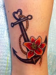 A painted anchor design that is combined with some beautiful flowers. 155 Cool Anchor Tattoo Designs And Its Meanings Rawiya