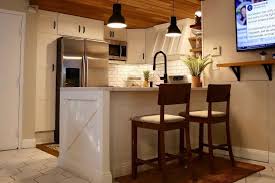 This modern kitchen is completed with a white herringbone backsplash, farmhouse sink, cement tile island, and leather bar stools. The Top 54 Kitchen Bar Ideas Interior Home And Design