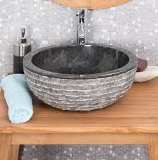 black stone sink with carved exterior