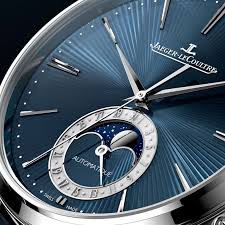 Time is exhibited on a blue guilloché pattern dial with a metallic base and translucent blue enamel. Pre Sihh Master Ultra Thin Moon Enamel Jaeger Lecoultre