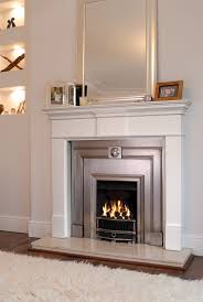 White fireplace surround with electric fire. Stovax Pembroke Wood Mantel