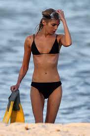 stella maxwell wears a black bikini as she emerges from the sea during a  photoshoot in miami, florida-060220_10