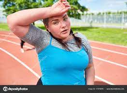 Chubby Girl Sportive Outfit Sweating Touching Her Forehead Workout Stadium  Stock Photo by ©pressmaster 177678976