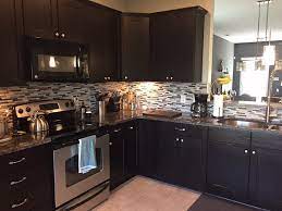 Thanks to the grayish stacked stone tiles. Dark Espresso Shaker Cabinets With Mosaic Tile Backsplash Transitional Kitchen Other By Unique Granite Marble Houzz