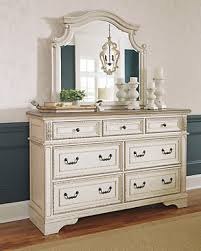 With a pair of chandeliers and a white wooden cabinet, a little charm goes a long way in this master space. Farmhouse Bedroom Dressers Chests Of Drawers Ashley Furniture Homestore