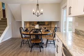 This contemporary kitchen's design allows the cook to face family and friends while preparing meals and looks out upon the main living space. Split Level House Open Concept Kitchen Dining Room