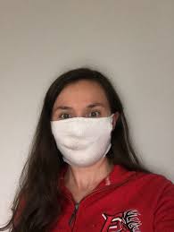 Jennifer Schindler-Ruwisch, Assistant Professor of Nursing, is teaching us  how to make a no-sew mask just like the one she's wearing in this photo!  You can learn too by following her video