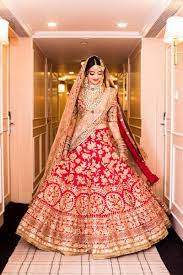 Photo Of Bride Showing Off Red And Gold Bridal Lehenga Bridal Lehenga Red Indian Bridal Dress Bridal Dress Design