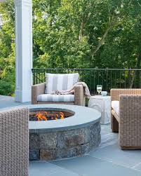 Cozy Round Fire Pit Made Of Concrete And Slate Tiles Is Surrounded By Outdoor Wicker Chairs With White And Gr Concrete Fire Pit Patio Concrete Fire Pits Patio