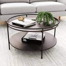 Round coffee tables round or oval coffee tables are good for gathering groups & easy to maneuver around. Nathan James Paloma 32 In Dark Oak Black Medium Round Wood Coffee Table With Tray 32001 The Home Depot