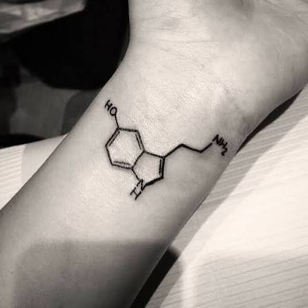 Wrist tattoo of the skeletal formula of serotonin on