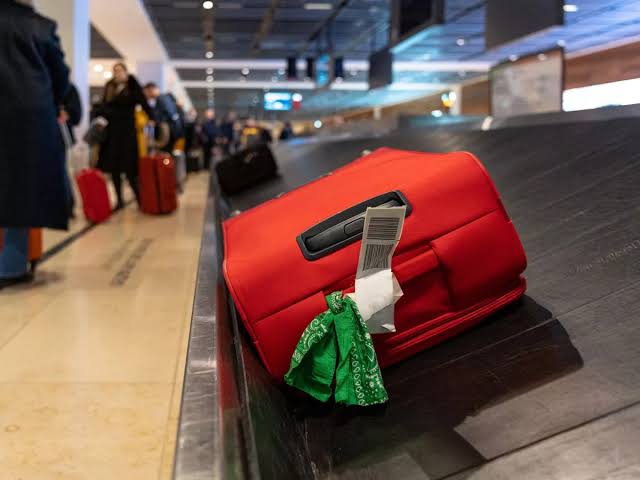 Baggage handler reveals why you should never tie a ribbon to your suitcase  - The Mirror