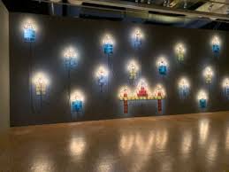 Metal boxes built into walls, bare lightbulbs hanging from the ceiling, cold light, stacks of worn and unworn clothes: An Homage To Christian Boltanski Judith Benhamou Huet Reports