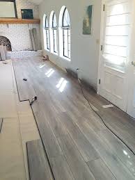 Laminate flooring has similar construction to engineered wood flooring, but the top veneer is a layer of tough film covered with plastic resins. Water Resistant Laminate Flooring Juniper Home Laminate Flooring Basement Home Remodeling Basement Remodeling