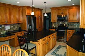 Detract from the heavy look of oak cabinets by opting for lighter tones in other areas of your kitchen. Black Pearl Marble Maple Kitchen Cabinets Black Granite Countertops Honey Oak Cabinets Oak C In 2021 Maple Kitchen Cabinets Brown Kitchen Cabinets Honey Oak Cabinets