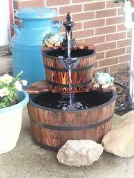 Insert the pump into the bottom of barrel and attach the hose. Pin By Kim Campbell On Whiskey Barrel Fountains Whiskey Barrel Fountain Barrel Fountain Wood Barrel Ideas