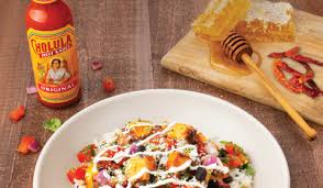Cholula hot sauce is most recognized by its iconic wooden cap and artistic mexican label. Qdoba Mexican Eats Introduces New Cholula Hot Sweet Chicken Markets Insider