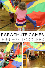 Fun Parachute Games That Keep Toddlers Moving Parachute Games Physical Activities For Toddlers Motor Skills Activities