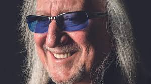 Born October 13th 1950 is Simon John Breckenridge Nicol he is an English  guitarist, singer, multi-instrumentalist and record producer. He was a  founding member of British folk-rock group Fairport Convention and is