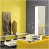 A stylish and modern bedroom in yellow, grey and white colors with a patterned accent rug. 1