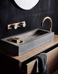Wood in bathrooms is an option, find out to safely feature epic wooden floors, wooden countertops, reclaimed wood vanity, wooden sinks and tubs and even wooden wall designs! A Wooden Vanity With A Concrete Sink And Brass Details Look Chic Bathroom Interior Bathroom Interior Design Bathroom Decor