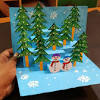 Glue the hill to the greeting card, then glue the building into place on the card, and lastly glue the person into place on the card. 3