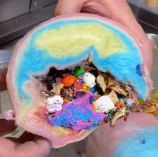 The inside of this burrito is more familiar to us, since it's just ice cream. Dessert Shop Offers Cotton Candy Burritos Stuffed With Ice Cream And Sweets