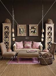 Living Room In Natural Shades With Dark Brown Wall Pink Scatter Cushions And Lilac Rug Add Cheerful Touches Dark Brown Walls Brown Walls Room