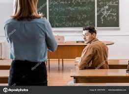 When placing students in the seating chart, always think, will this student talk to the students next to him or her, either next to or in. Back View Female Teacher Looking Male Student Sitting Desk Lesson Free Stock Photo C Vitalikradko 229019750