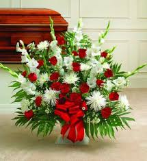 The most common way would be a stand that consists of carnations, roses and lilies, but there are a variety of other ways. Red And White Sympathy Floor Basket Premium Roslindale Florist